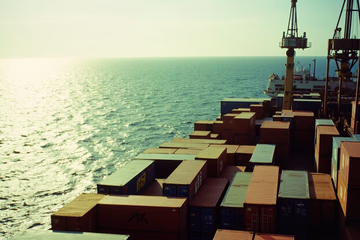 Containers floating on a calm sea, guided by a central ship, representing Docker and Kubernetes working together.