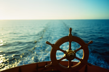 A ship's helm surrounded by a calm, blue ocean, symbolizing Kubernetes' control over container orchestration.