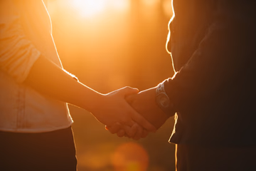 Warm sunlight on a couple holding hands in Colmar, symbolizing rekindled love.