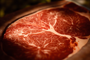 Close-up of meat marbling, showcasing quality control in meat production.