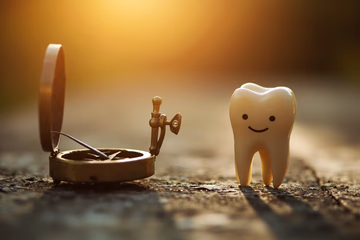 A compass pointing towards a smiling tooth, symbolizing direction and success in dental marketing.
