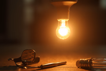 A bright lightbulb illuminating dental tools, symbolizing dental marketing enlightenment.