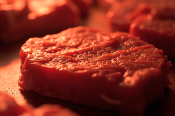 Meat sample being analyzed with infrared spectroscopy for quality and safety assurance.
