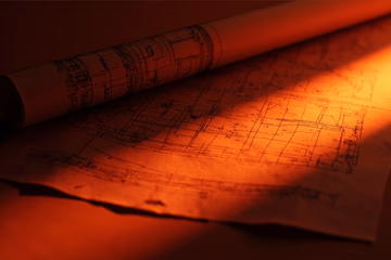 Blueprint representing a business plan, symbolizing expert support for business success.